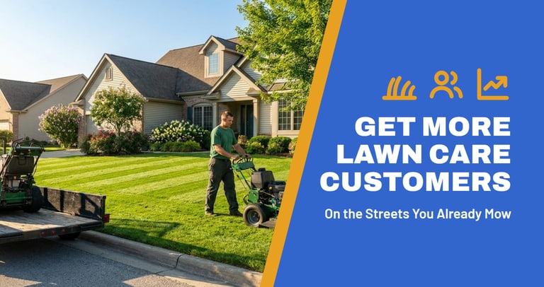Lawn care crew member mowing fresh stripes into a front lawn with a trailer parked at the curb